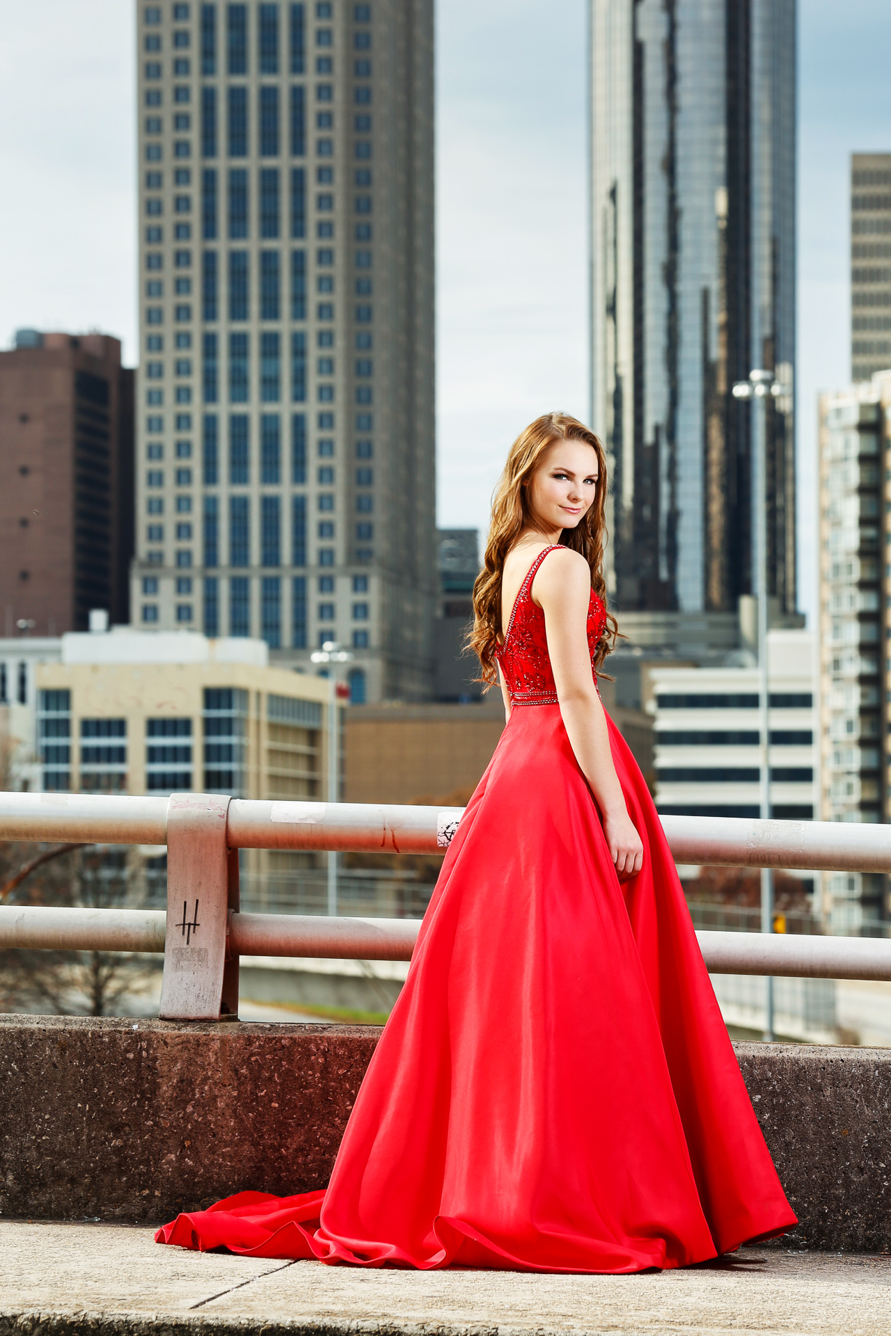 Editorial Senior Photoshoot with a natural beauty in a red dress. Photographed overlooking the skyline of Atlanta. 