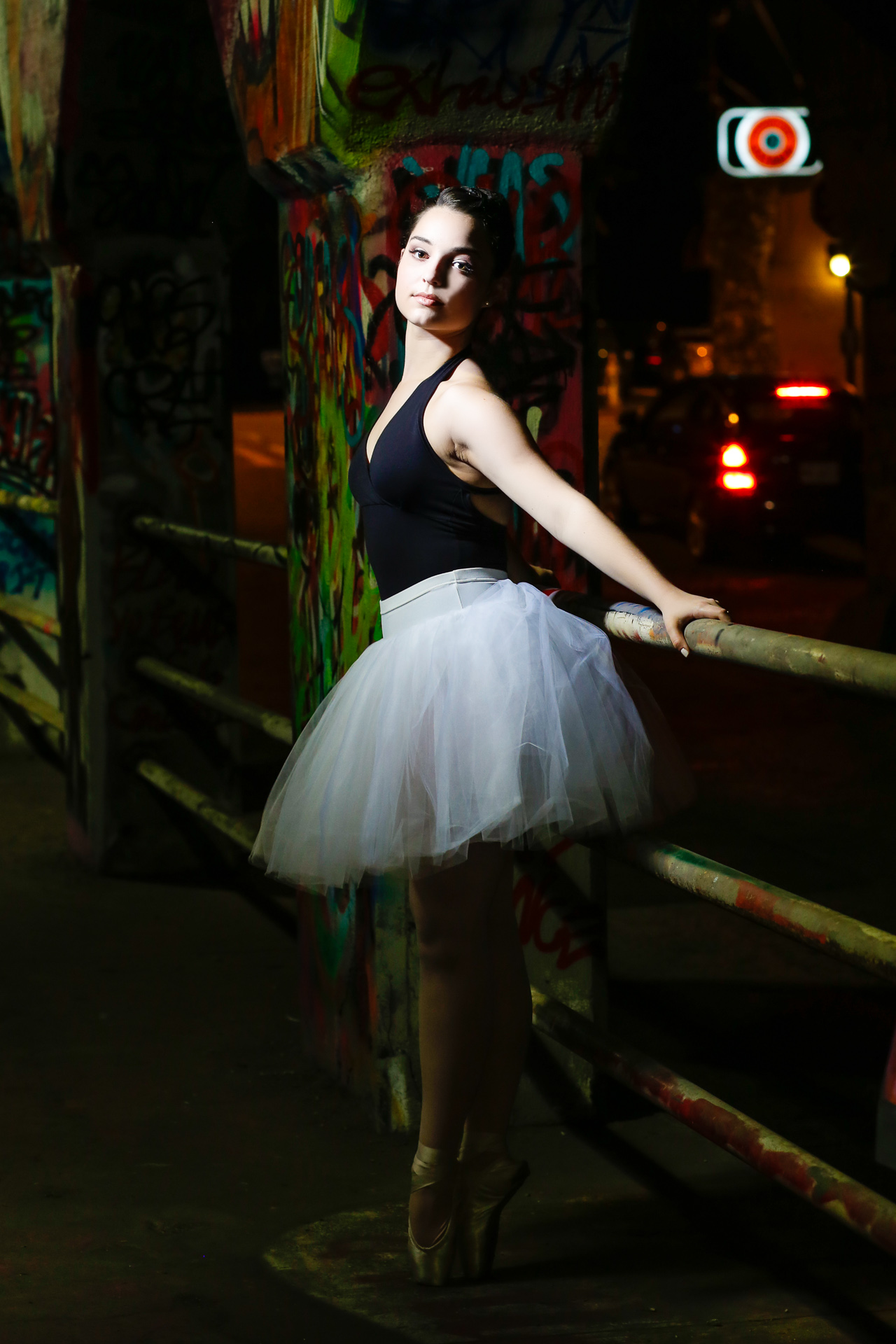 Ballerina dance pictures taken at Krog Street in Atlanta, GA. This look was inspired by Misty Copeland and her white tu-tu and black leotard. The  High School Senior session was full of dance poses and dramatic lighting. Images captures with Urban Flair Photography, Starr Petronella