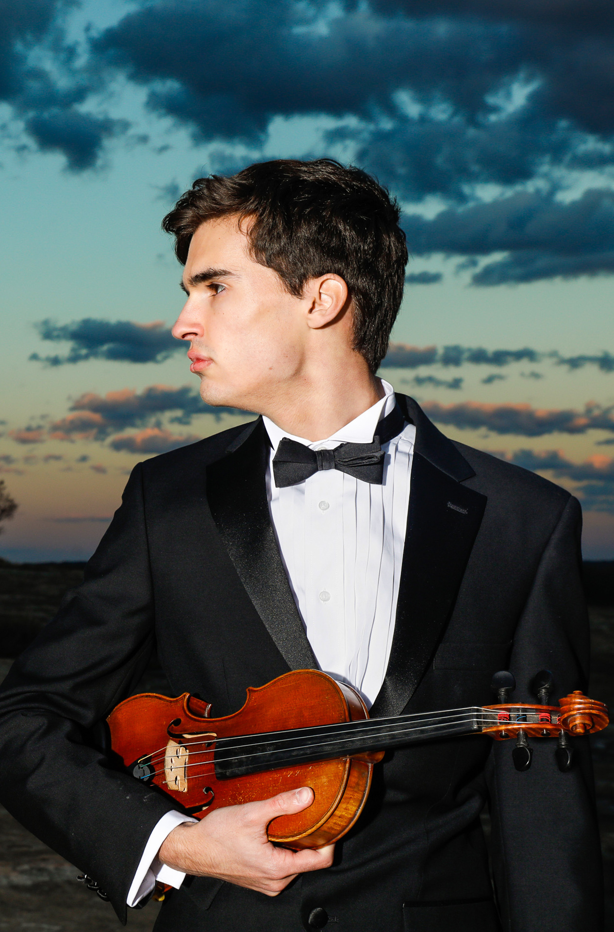 Sams highlight of his senior portraits happened when we had the most amazing sunset ever. He wore his tux and played his violin as the sun dropped over the mountain. Starr Petronella of Urban Flair Photography was able to capture so many unique angles of him. The high school senior portraits were unlike any taken before. The music just filled the air and dance around the sky while the photos were taken. Breathtaking.!